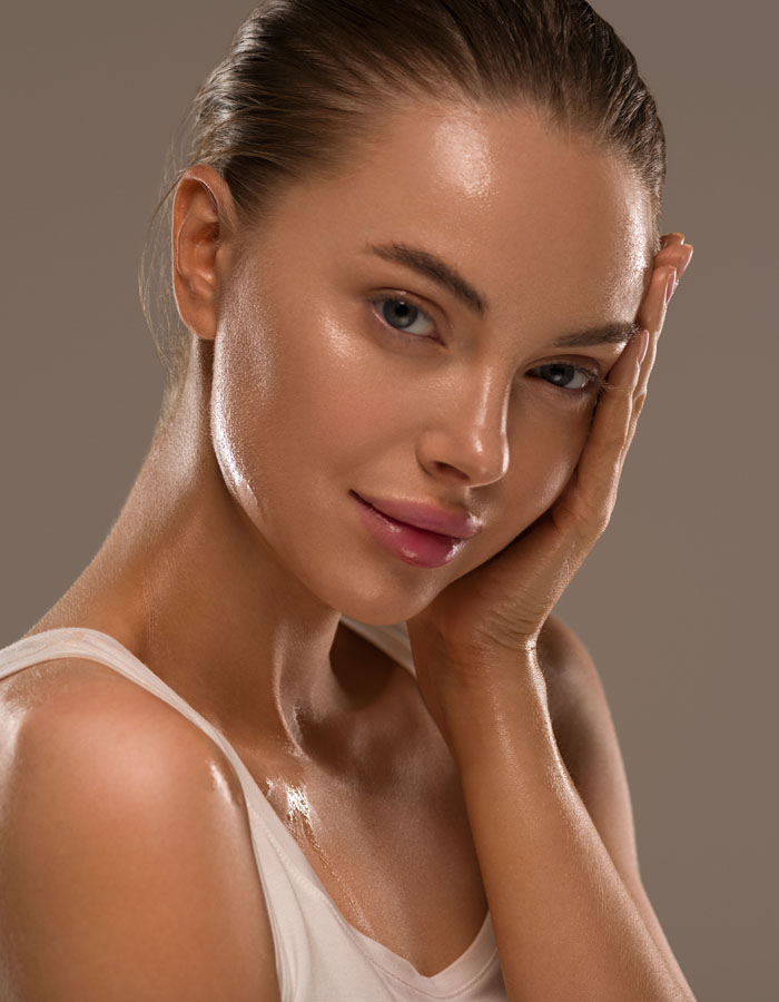Woman with flawless skin touching her face