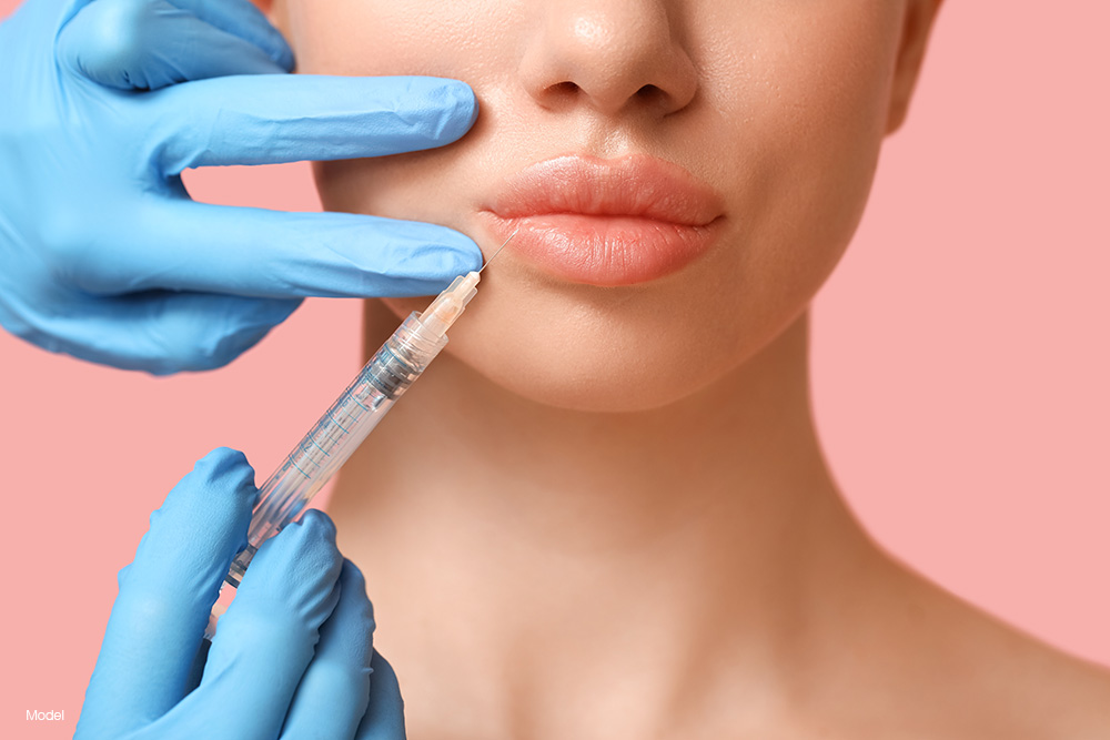 Woman getting an injection into her lip
